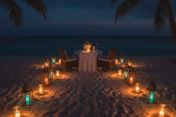 Candle-lit dinner for two on a night beach