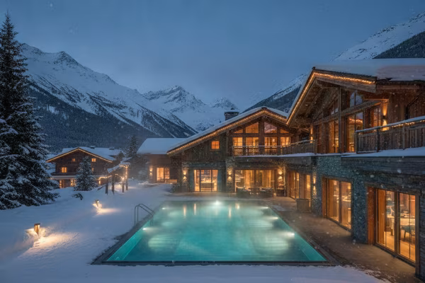 Swiss alpine chalet with steaming pool in snow